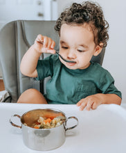 Load image into Gallery viewer, A baby boy is eating a pasta from a Kiddobloom fire truck stainless steel bowl using a Kiddobloom fire truck stainless steel kids spoon.
