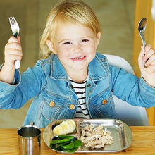 Load image into Gallery viewer, A toddler girl eats chlcken with spinach meal from a kids stainless steel divided plate using toddler safe  stainless steel utensils. A stainless steel baby cup is next to the stainless plate.
